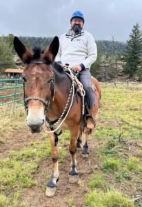 Pastor Ethan riding a mule