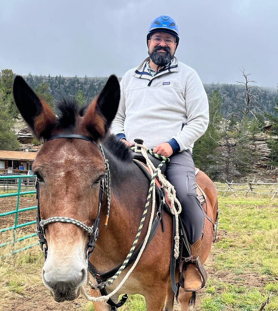 Pastor Ethan riding a mule